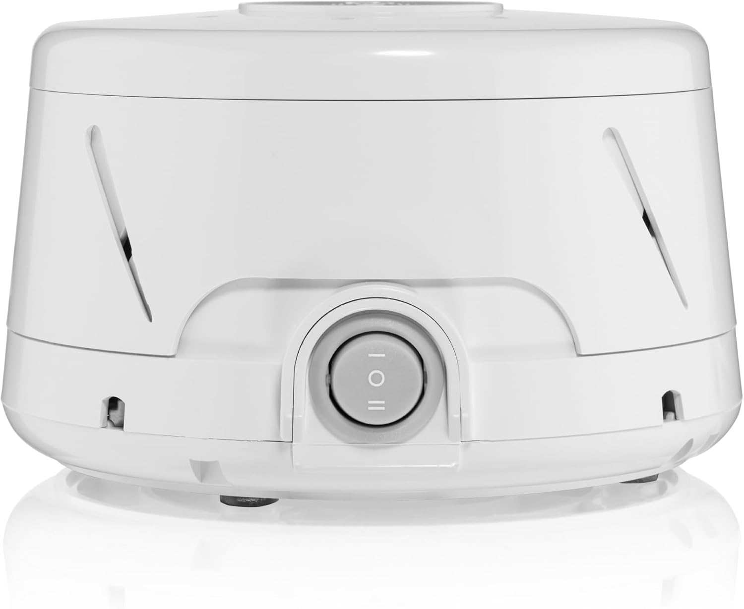 White Yogasleep Dohm Classic white noise sound machine with round fan-based housing on a bedside table